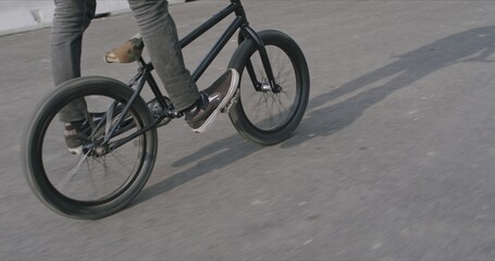 Fototapeta na wymiar Extreme bmx cyclist doing bike tricks