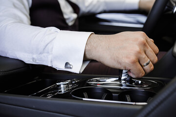 close up of a hand holding a car