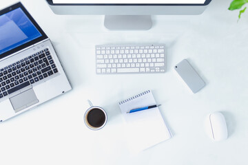 White office space. Laptop on table with office material...