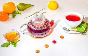 Red fruit tea with rose leaves. Foam tea with spices on the table in a cafe