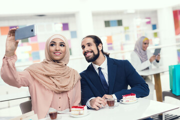 Arabian Couple Sitting in Cafe after Shopping.