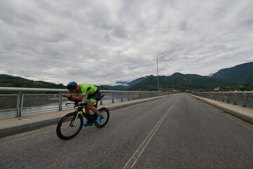 Fototapeta premium triathlon athlete riding a bike on morning training
