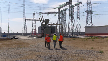 Anonymous team walking on power station
