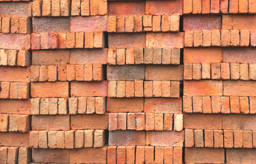 Pile of red bricks at construction site. abstract texture background.