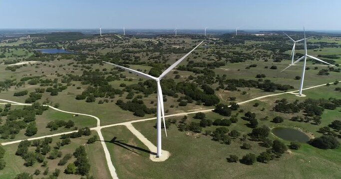 Aerial video of Wind Turbines near Comanche Texas.  Camera trucks right to reveal more wind turbines.
