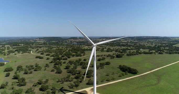 Aerial video of a wind turbine.  Camera backs away from the wind turbine revealing vast open field.  This was shot near Comanche Texas.