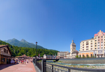 Russia, Sochi, Rosa Khutor, Mzymta river, hotels on the embankment, tourists walking, August 2015