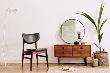 Minimalistic and stylish composition of living room with wooden commode, mirror, chair , lamp,...