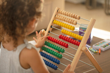 Little girl with abacus. children math education concept
