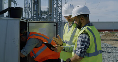 Engineer showing power transformer to inspectors