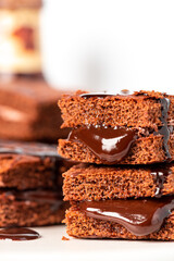Tasty homemade chocolate cake with chocolate filling on a white background close-up. Stack of chocolate brownies. Sweet food, homemade cakes. 