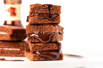 Tasty homemade chocolate cake with chocolate filling on a white background close-up. Free space for...