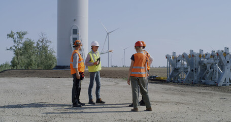 Group of builders discussing power plant construction site