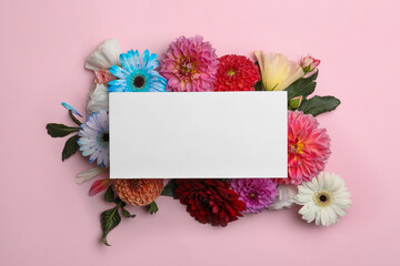 Flat lay composition with blank card, dahlia and gerbera flowers on pink background. Space for text