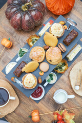 A beautiful gourmet selection of english afternoon tea cakes and scones served with organic...