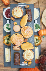A beautiful gourmet selection of english afternoon tea cakes and scones served with organic...