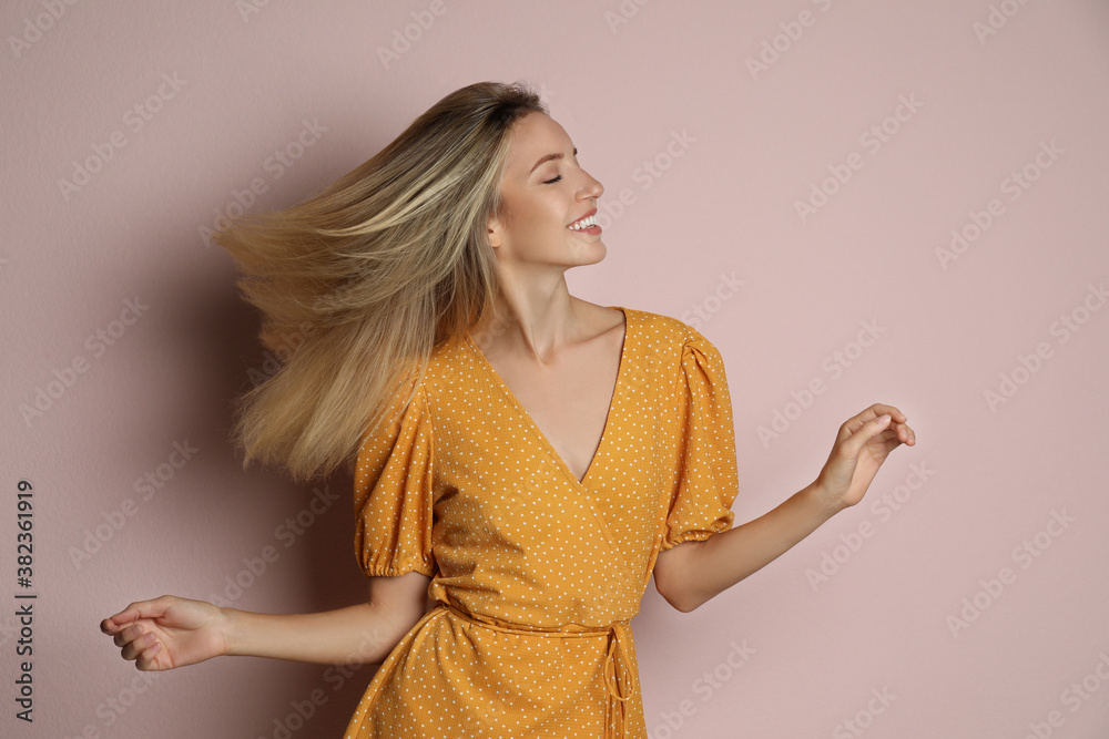 Poster Young woman wearing stylish dress on pale pink background