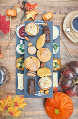 A beautiful gourmet selection of english afternoon tea cakes and scones served with organic...