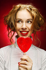 woman with heart caramel over red background