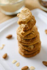 Stack of Gluten Free Almond Cookies set on white cafe table.