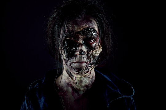 Scary zombie on dark background. Halloween monster