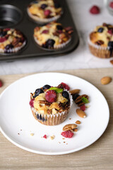 mixed berry low carb Keto Diet muffin with almond and nut. set on cafe table.