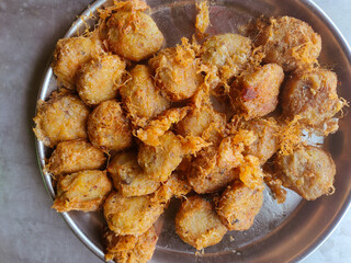  potato fritters on an aluminum plate on the table