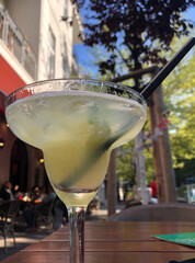 Cocktail glass on bar table outdoors