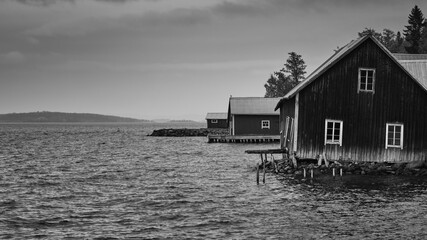 old broken boathouse by the sea on a cloudy day