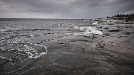 wet cliffs in the foreground and the sea in the background, cloudy weather