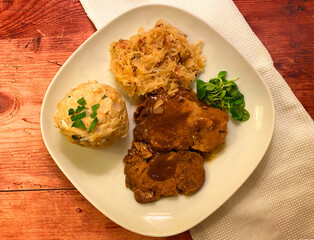 Classic dish. Tender and juicy pork roast with gravy, Sauerkraut and bread dumpling.