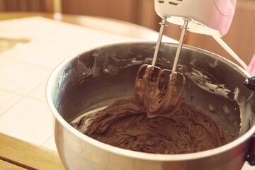 Mixing Chocolate cheese cream for cakes with a mixer