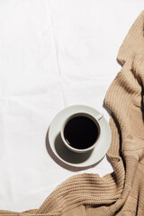 a Cup of coffee and a blanket on the bed. the concept of home comfort