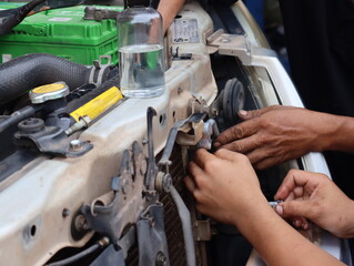 Mechanic working on the engine in an auto repair shop