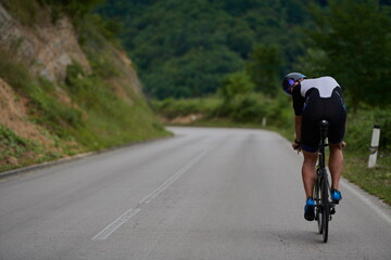 triathlon athlete riding a bike wearing black