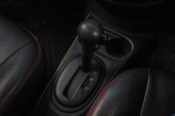 Fototapeta na wymiar automatic transmission shift selector in the car interior. Closeup a manual shift of modern car gear sifter.