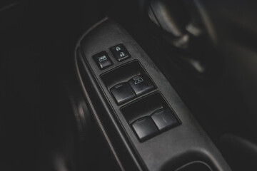 Car arm rest with Control Panel. Door Lock & Mirror Control. window adjustment buttons, door lock. Photography of a modern car.