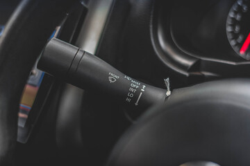 Windscreen wiper control switch in car. Wipers control. Modern car interior detail. adjusting speed of screen wipers in car.