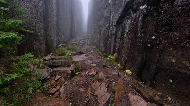 High cliffs on both sides at once leading away in foggy weather