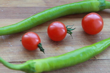 cherry tomatoes and green chili pepper. image of  tomatoes and chili peppers