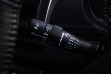 Windscreen wiper control switch in car. Wipers control. Modern car interior detail. adjusting speed of screen wipers in car.