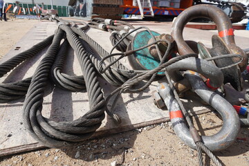 Fototapeta na wymiar Shackles and wire slings set on the ground in heavy duty industrial or oil and gas plant.