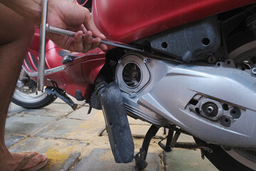 Mechanic man hand fix CVT scooter motorbike at home