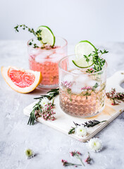 summer homemade juice with lime and blossom on stone table background