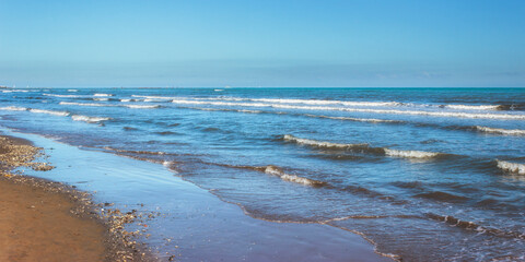 The coast of the Adriatic Sea in calm, clear weather. Rimini, Italy
