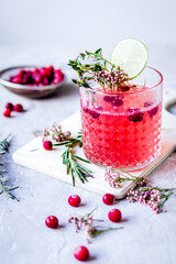 summer homemade juice with lime and berries on stone table background