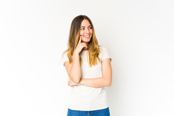 Fototapeta premium Young caucasian woman isolated on white background relaxed thinking about something looking at a copy space.