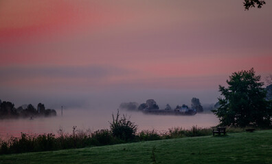 ship transport sunrise over the river maas in Holland