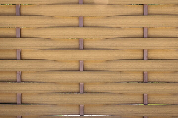 Bamboo straw mat. Abstract background texture of wicker bamboo fence.