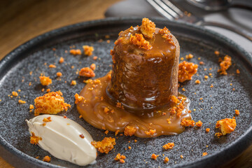 Sticky toffee pudding with cream and honeycomb